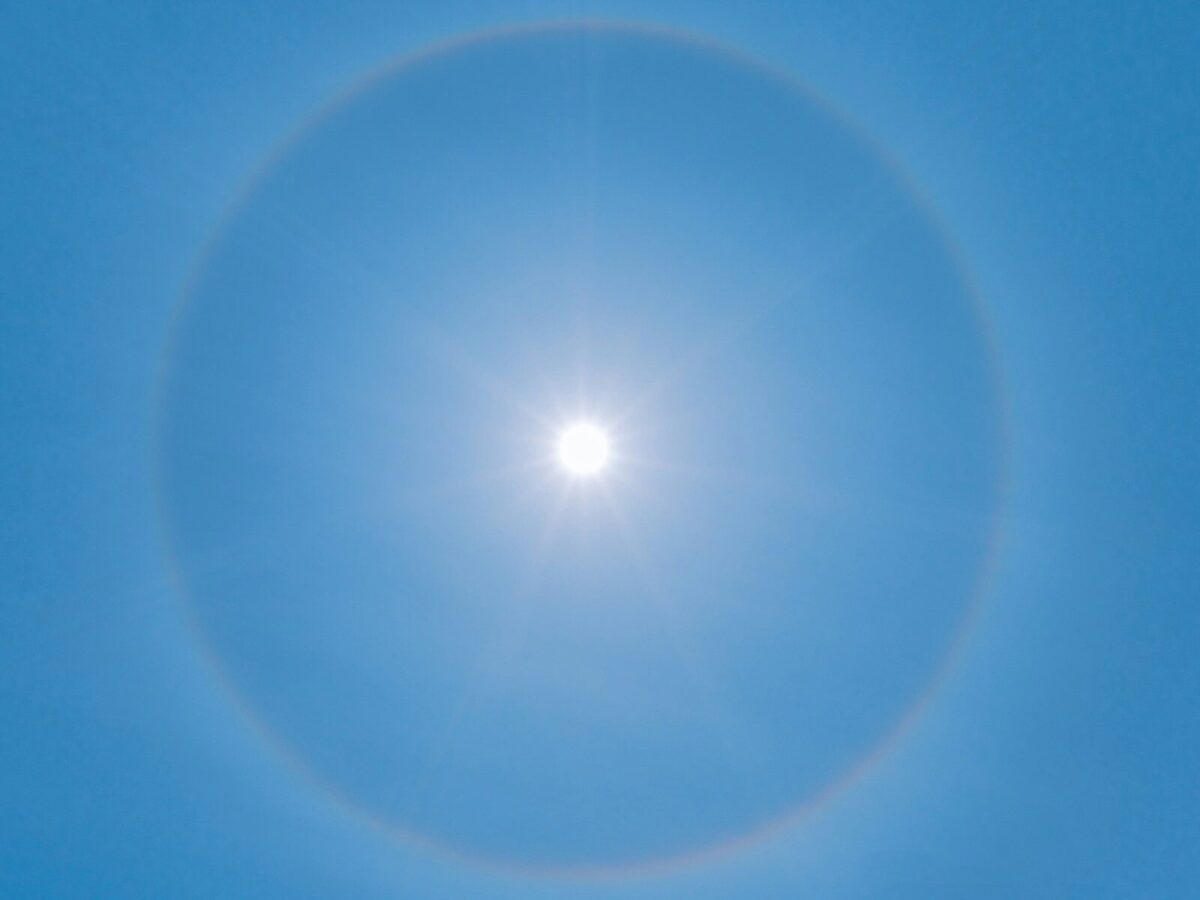 blue sky with white sun